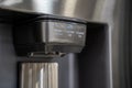 Close up of modern refrigerator water and ice dispenser panel Royalty Free Stock Photo