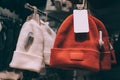 Close-up, modern winter hats with label mockup, on a supermarket showcase