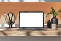 Close up of wooden designer desktop with empty white mock up place on laptop screen, coffee cup, supplies and other items. Royalty Free Stock Photo