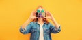 Close up of modern young woman stretching her hands taking selfie with smartphone on yellow background Royalty Free Stock Photo