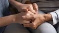 Close up of mom and daughter hold hands sharing secrets