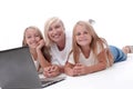 Close up. mom and daughters lying in front of an open laptop. Royalty Free Stock Photo