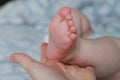 Close-up of mom hand holding baby foot Royalty Free Stock Photo