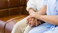 Hands of mother reassuring her daughter while sick