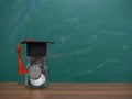 Close up money in the glass bottle with graduation hat. The concept of saving money for education, student loan, scholarship, Royalty Free Stock Photo