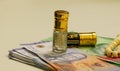 Close up of money, Indonesian rupiah banknote and perfume and prayer beads, in shallow focus