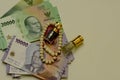 Close up of money, Indonesian rupiah banknote and perfume and prayer beads, in shallow focus