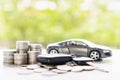 Close up of money and model car with car keys on white table on green bokeh background. Collect money to buy a new car  saving and Royalty Free Stock Photo