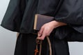 Close up of monk hands holding book and rosary . Royalty Free Stock Photo