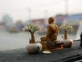 A monk statue being placed on a driving car dashboard in Thailand as the Thais believe that the statue save them from road acciden Royalty Free Stock Photo