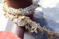 Close-up of a mooring rope with a knotted end tied around a cleat Royalty Free Stock Photo