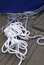 Close-up of a mooring rope with a knotted end tied around a cleat on a wooden pier Nautical mooring rope Royalty Free Stock Photo