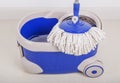 Close up of mop and blue bucket for cleaning floor Royalty Free Stock Photo