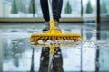 Close-up of a mop cleaning the floor in a hotel lobby. Low section of woman cleaning floor. Mopping floor. Cropped close-up of