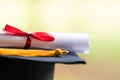 Close-up of a mortarboard and degree certificate put on table. Education stock photo Royalty Free Stock Photo