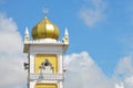 Close up of mosque tower with golden dome