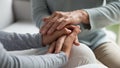 Close up of mother and adult daughter hold hands Royalty Free Stock Photo