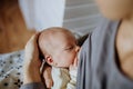 Close-up of mother brestfeeding her little newborn baby.