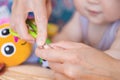 Close-up mother cutting nail of baby with safety scissors. Mom trimming child fingernails. Children healthcare and hygiene concept