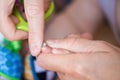 Close-up mother cutting nail of baby with safety scissors. Mom trimming child fingernails. Children healthcare and hygiene concept