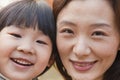 Close-up of Mother and Daughter smiling in the park, autumn, Portrait Royalty Free Stock Photo