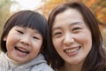 Close-up of Mother and Daughter smiling in the park, autumn, Portrait Royalty Free Stock Photo