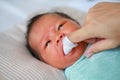 Close-up mother hand clean baby tongue and gum with the clean gauze Royalty Free Stock Photo