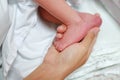 Close up mother hand holding newborn baby feet Royalty Free Stock Photo