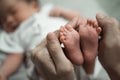 Mother hands holding baby feet Royalty Free Stock Photo