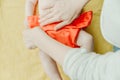 Close up of mother hands put on a baby orange diaper to her newborn Royalty Free Stock Photo