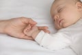 Close up of mother hold hand of sleeping newborn baby