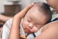 A close-up of mother holding newborn baby at home, Infant chlid sleeping on the mom chest, Family concept