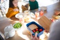 Close-up of mother preparing snack to lunch box in kitchen at home. Royalty Free Stock Photo