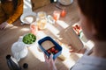 Close-up of mother preparing snack to lunch box in kitchen at home. Royalty Free Stock Photo