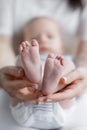 Close-up of mother`s hands and baby`s feet Royalty Free Stock Photo
