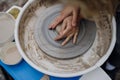 Close up of Mother teaching son how make pottery on pottery wheel. Child creative activities and art. Boy making pottery