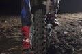 Close up of motocross wheel on the background of the track while driver sitting on the bike
