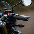 Close-up of a motorcycle handlebar featuring a textured black grip and a prominent Royalty Free Stock Photo