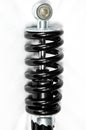 Close up of motorcycle shock absorber spring on white