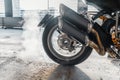 Close up of motorcycle wheel burnout at parking.