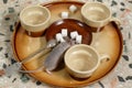 Close-up mouse climbs on a plate of sugar on a round tray with empty coffee cups. Top view. Royalty Free Stock Photo