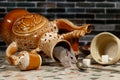 Close-up mouse comes out of an overturned ceramic jug on the countertop in the kitchen. Royalty Free Stock Photo