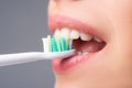 Close-up mouth with teeth-brush, toothbrush. Smiling young woman with healthy teeth holding a tooth brush. Dental health Royalty Free Stock Photo