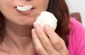 Close up with the mouth of a woman eating onion