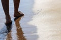 Close up on moving feet of a man walking on the beach in the afternoon at Koh Mak in Trat, Thailand
