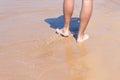 Close up on moving feet of a man walking on the beach