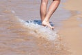 Close up on moving feet of a man walking on the beach