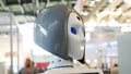 Close-up of moving and speaking female robot`s head with blue eyes. Media. Different working robots collection presented