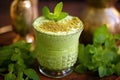 close-up of muddling mint and lime in a glass