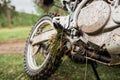 Close-up of muddy rear wheel of dirt bike, details.